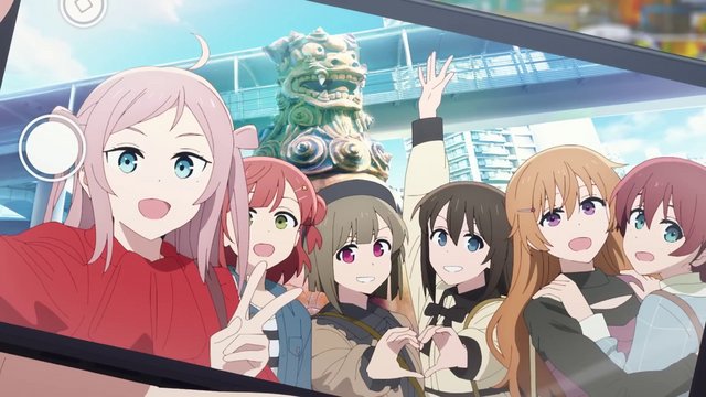 Group photo in front of a giant colorful shisa statue
